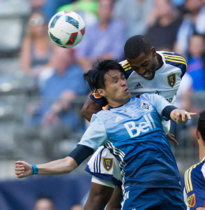 Vancouver Whitecaps' Masato Kudo, front, of Japan, and Real Salt Lake's Aaron Maund battle for the ball during the first half of an MLS soccer game on Wednesday July 13, 2016, in Vancouver, British Columbia. (Darryl Dyck/The Canadian Press via AP)